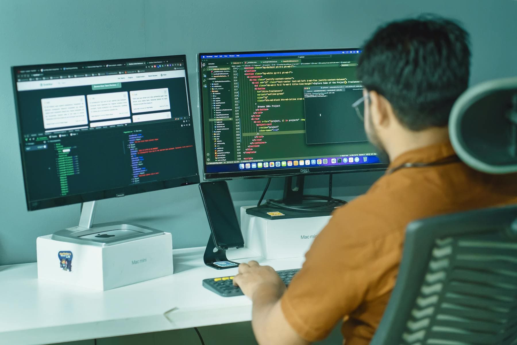 Software developer coding on dual monitors in a modern office