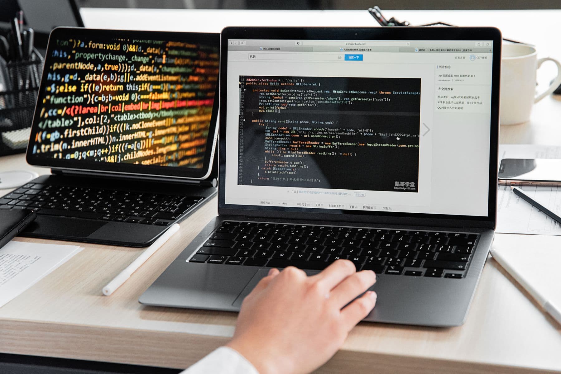 Developer writing code on a laptop in an office